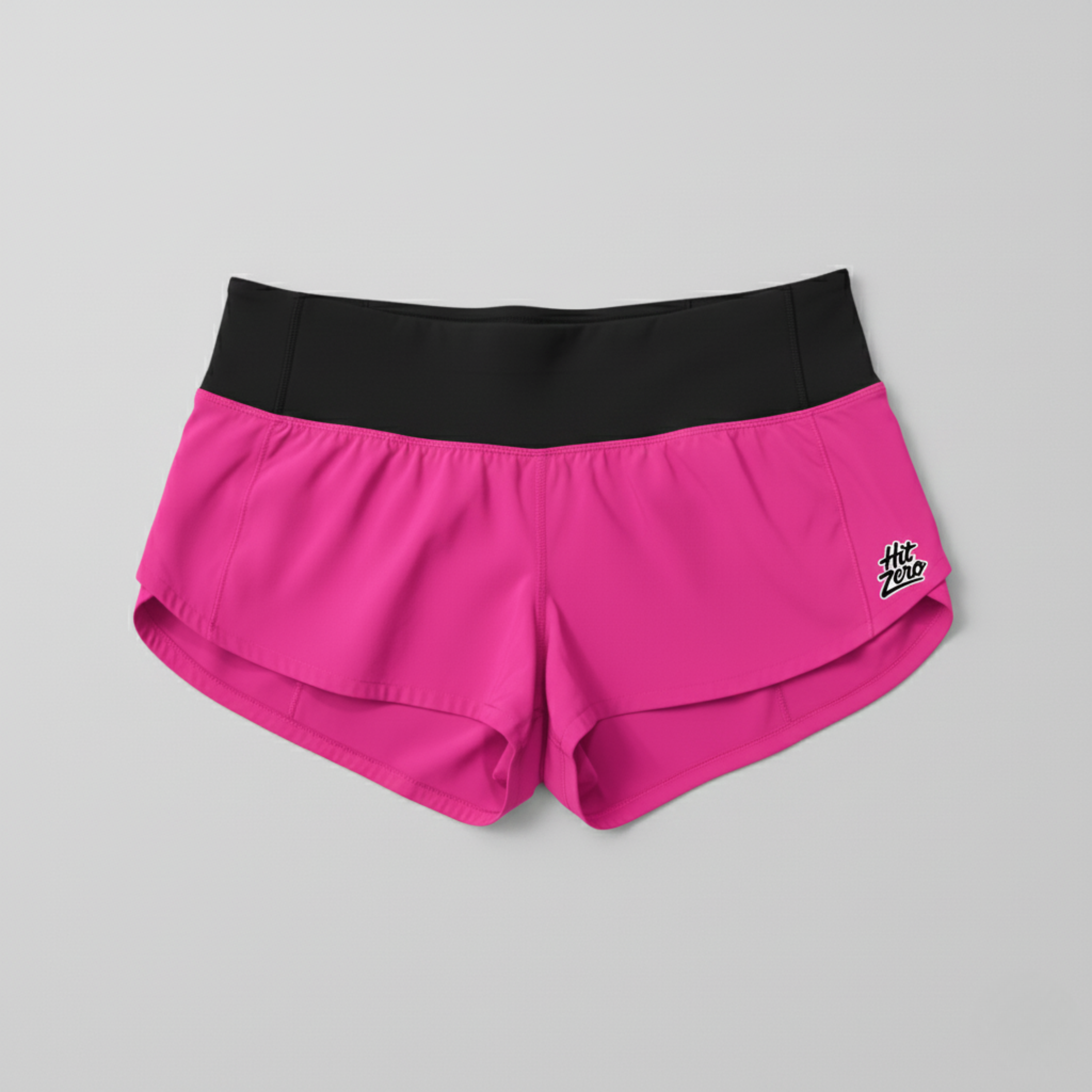 Low-rise Hot Pink cheer shorts (2.5" inseam) with wide black waistband and Hit Zero Athletics logo on the left leg.